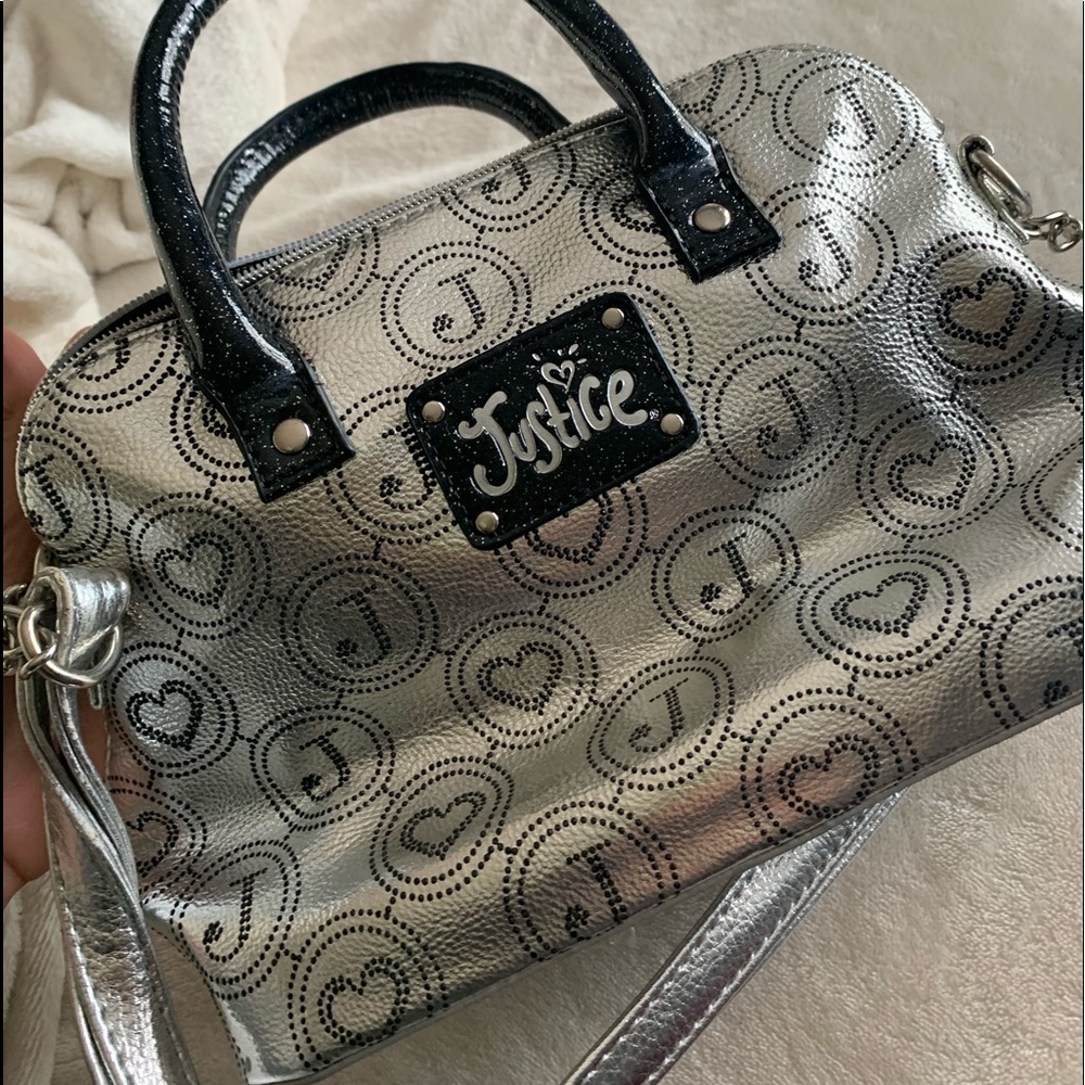 A silver and black justice purse
